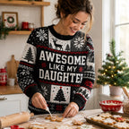 woman icing christmas cookies while wearing an ugly christmas sweater with reindeer
