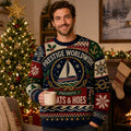 man wearing a navy and red ugly christmas sweater with a sailboat