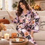 model reading on couch in matching halloween satin pajama set