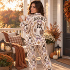 model glancing back on an autumn porch in cream Boo-Jee ghost satin pajamas