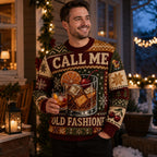 man in a funny old fashioned cocktail christmas sweater holding a drink