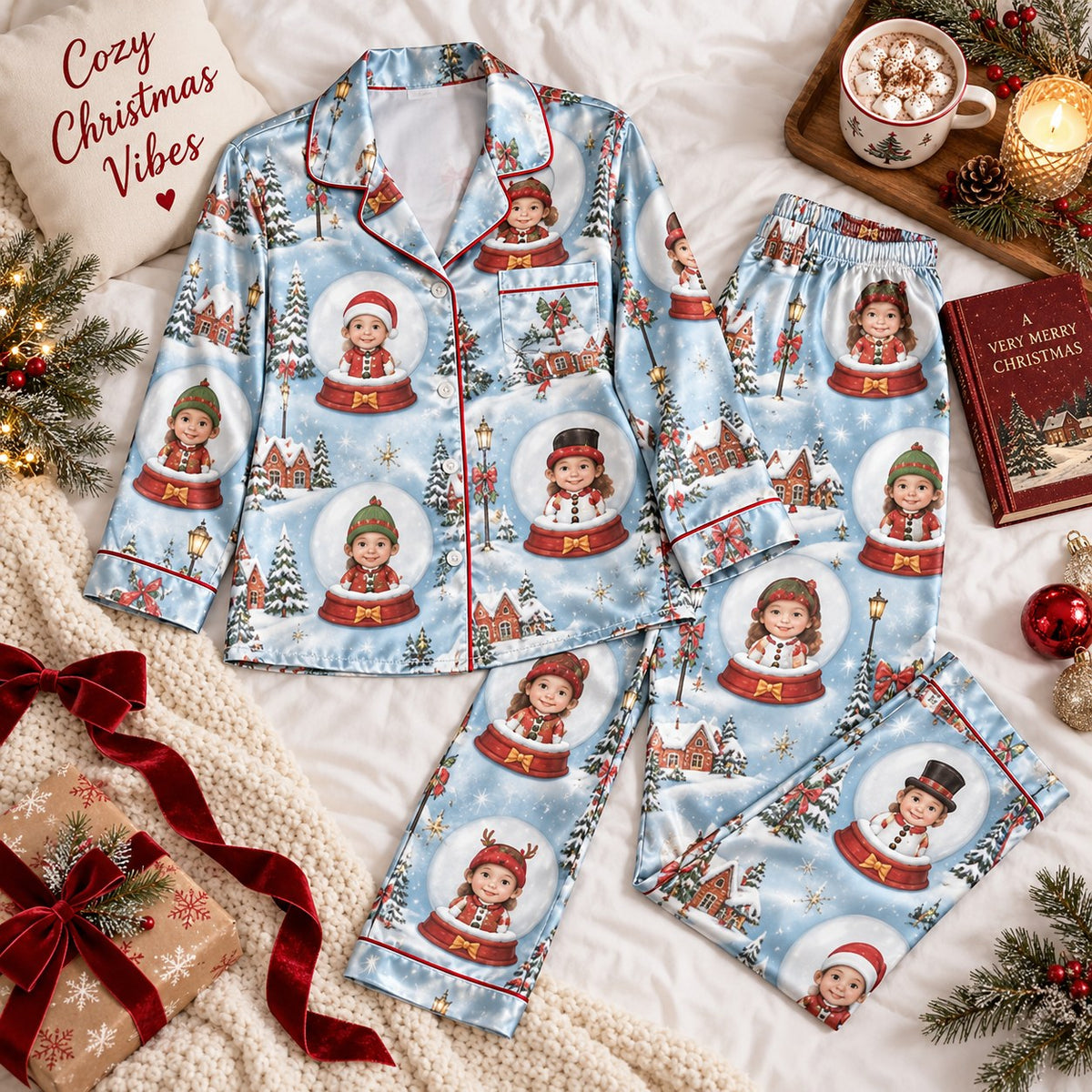 flat lay of light blue satin pajamas printed with kids in snow globes