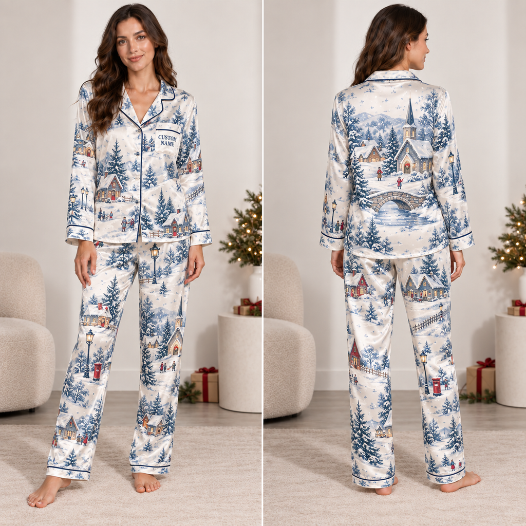 woman wearing christmas village satin pajama set in front of decorated tree