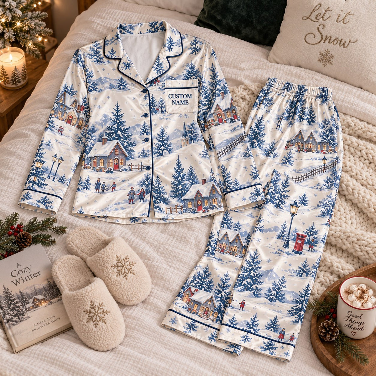 flat lay snowy winter village satin pajamas with a custom name on the chest