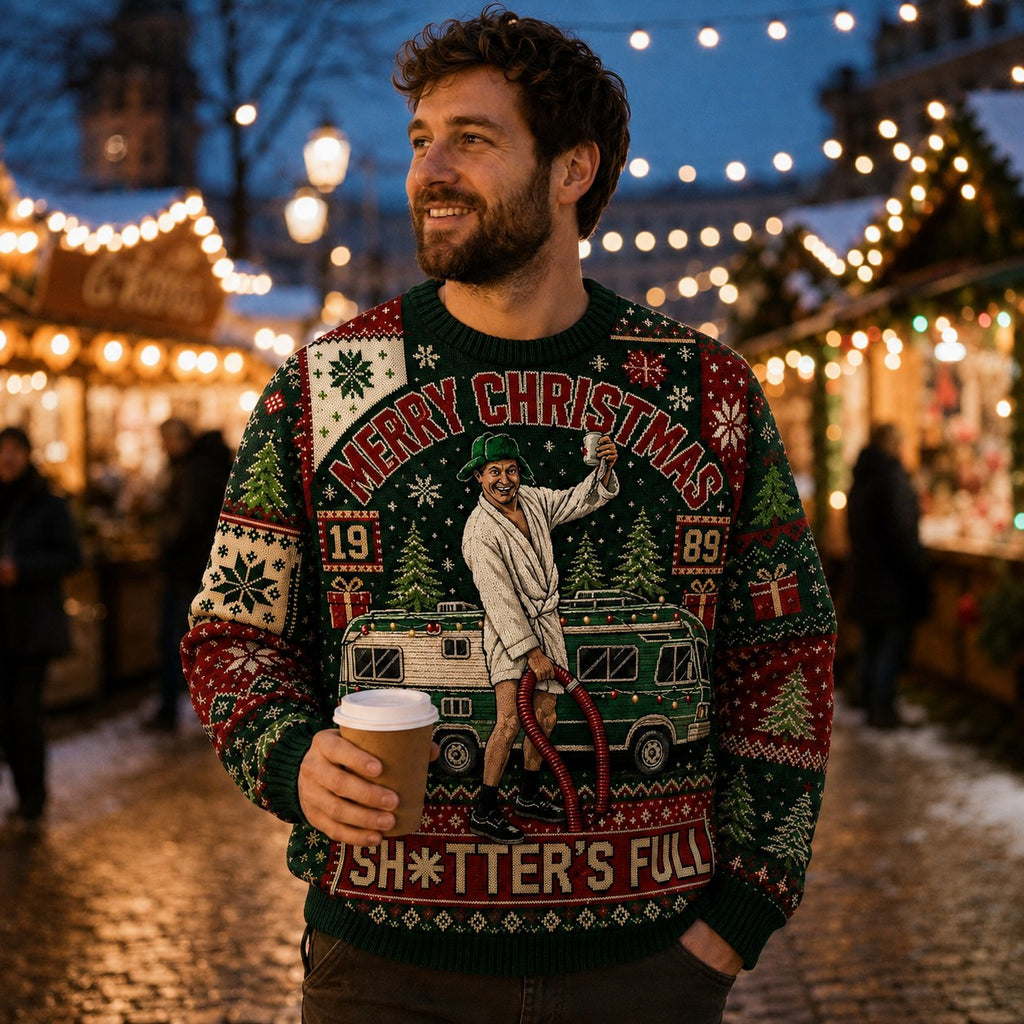 man smiling outdoors at a lit christmas market wearing a clark griswold