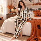 woman modeling halloween satin pajama set in a cozy decorated living room