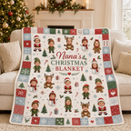 fleece christmas blanket draped over a white sofa next to a decorated