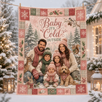 pink and green plaid christmas throw blanket hanging on a snowy porch