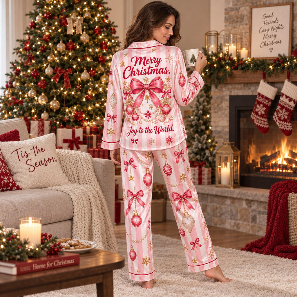 model standing in a pink candy stripe satin christmas pajama set in