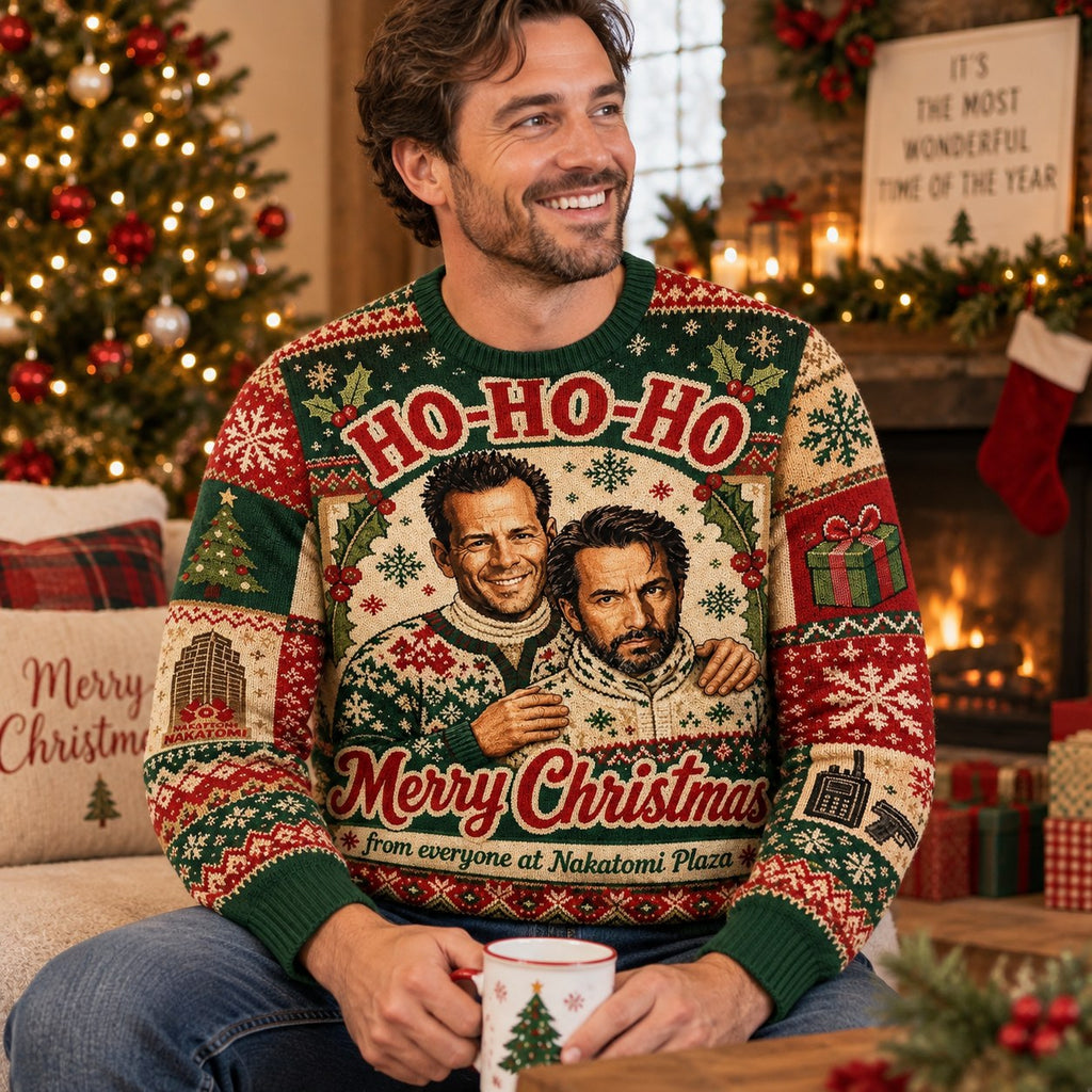 man in a die hard merry christmas sweater holding a hot cocoa