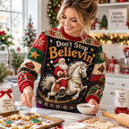 blonde woman smiling in a kitchen, wearing the don't stop believin' santa