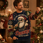 man wearing an ugly christmas sweater with a sunglasses santa drinking a