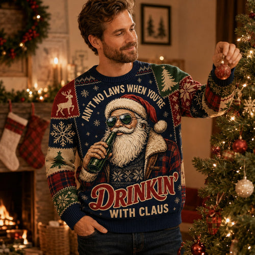 man wearing an ugly christmas sweater with a sunglasses santa drinking a