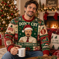man in ugly christmas sweater with dwight schrute santa hat print holding