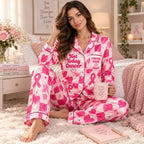 seated lifestyle photo of woman in pink checkered breast cancer awareness pajama