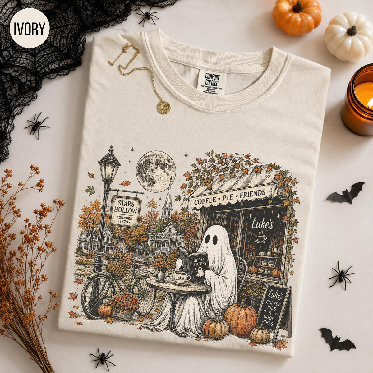 ivory graphic tee with ghost reading at autumn coffee shop