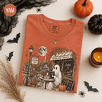 rust orange graphic tee with autumn village and bicycle