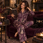 model holding a mug while wearing a witchy woman halloween satin pajama