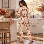 satin pyjama set with pumpkin heart print styled on cream bouclé chair