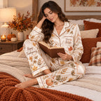 side view of a woman reading in the fall leaves satin pyjamas