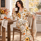 seated model in pumpkin and sunflower satin pyjamas holding a coffee mug