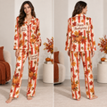 woman modeling thanksgiving satin pyjamas with pumpkins and stripes in a fall
