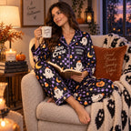 woman reading in purple ghost satin pajamas with a custom name on the chest