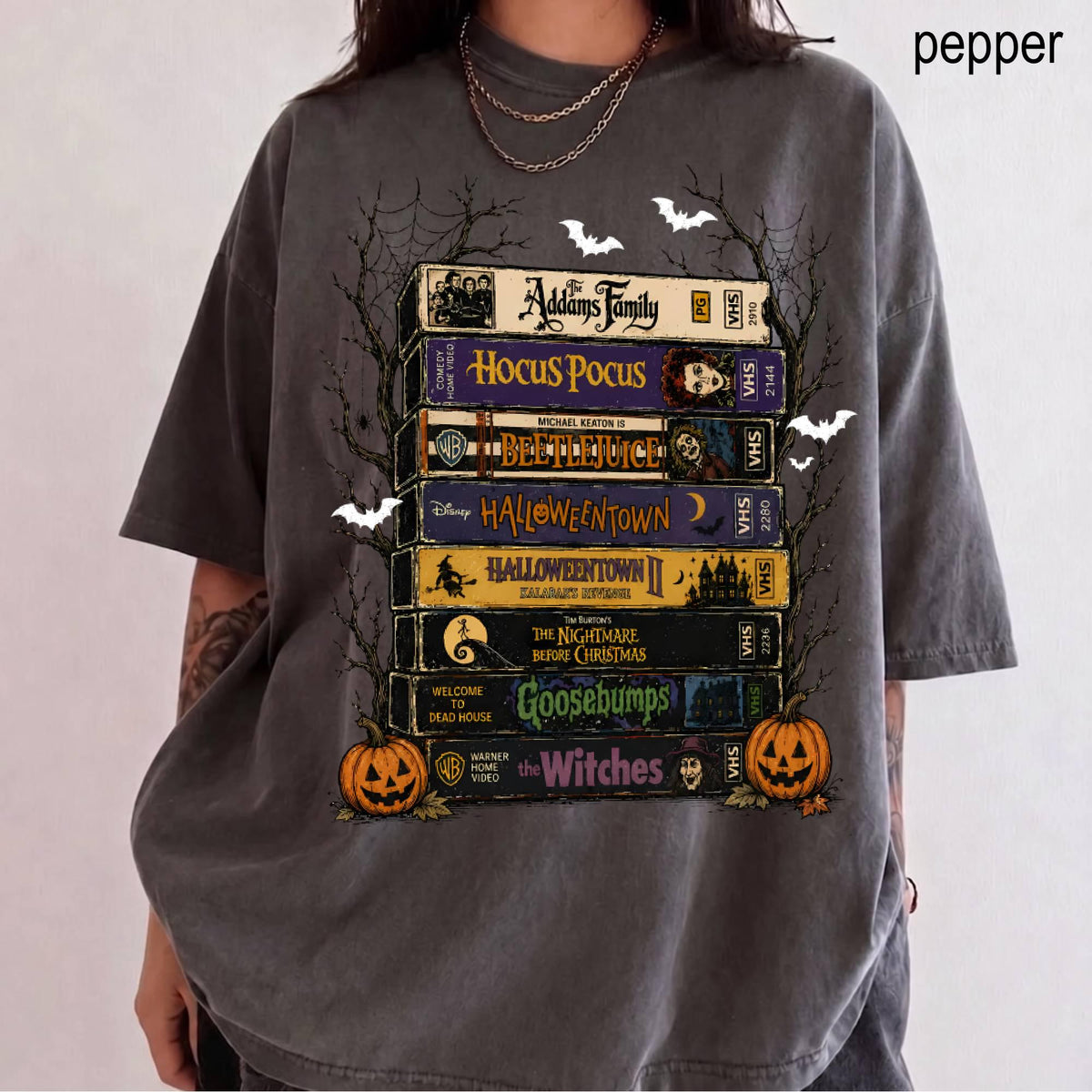 charcoal grey t shirt featuring vhs movie stack and spooky trees design