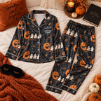 black pumpkin ghost satin pajamas flat lay with a custom name on the chest