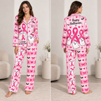 front view of pink satin pyjamas with smiling ghosts, pink ribbons and
