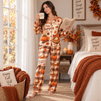 woman in button up satin pyjamas holding pumpkin pie in cozy kitchen
