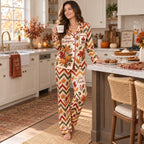 woman reading on the bed wearing thanksgiving print satin pyjamas