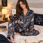 woman reading a book in haunted library halloween pajamas on a bed