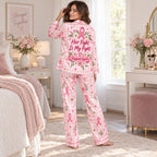 woman reading in chair with breast cancer support satin pajamas