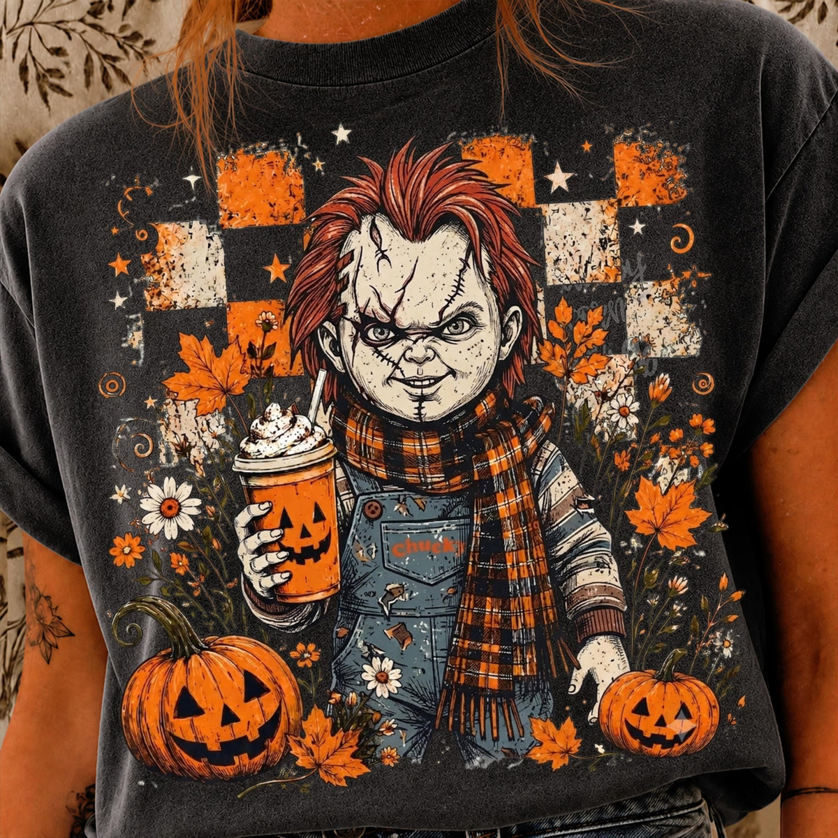 graphic tee featuring Chucky doll in overalls and a plaid scarf holding