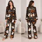 woman modeling a black satin pajama set with halloween ghost and pumpkin