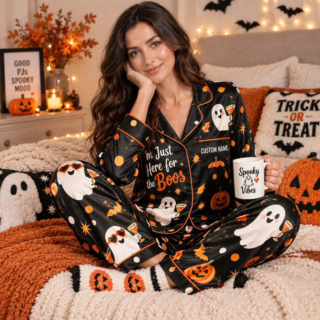 woman sitting on a bed holding a Spooky But Comfy mug