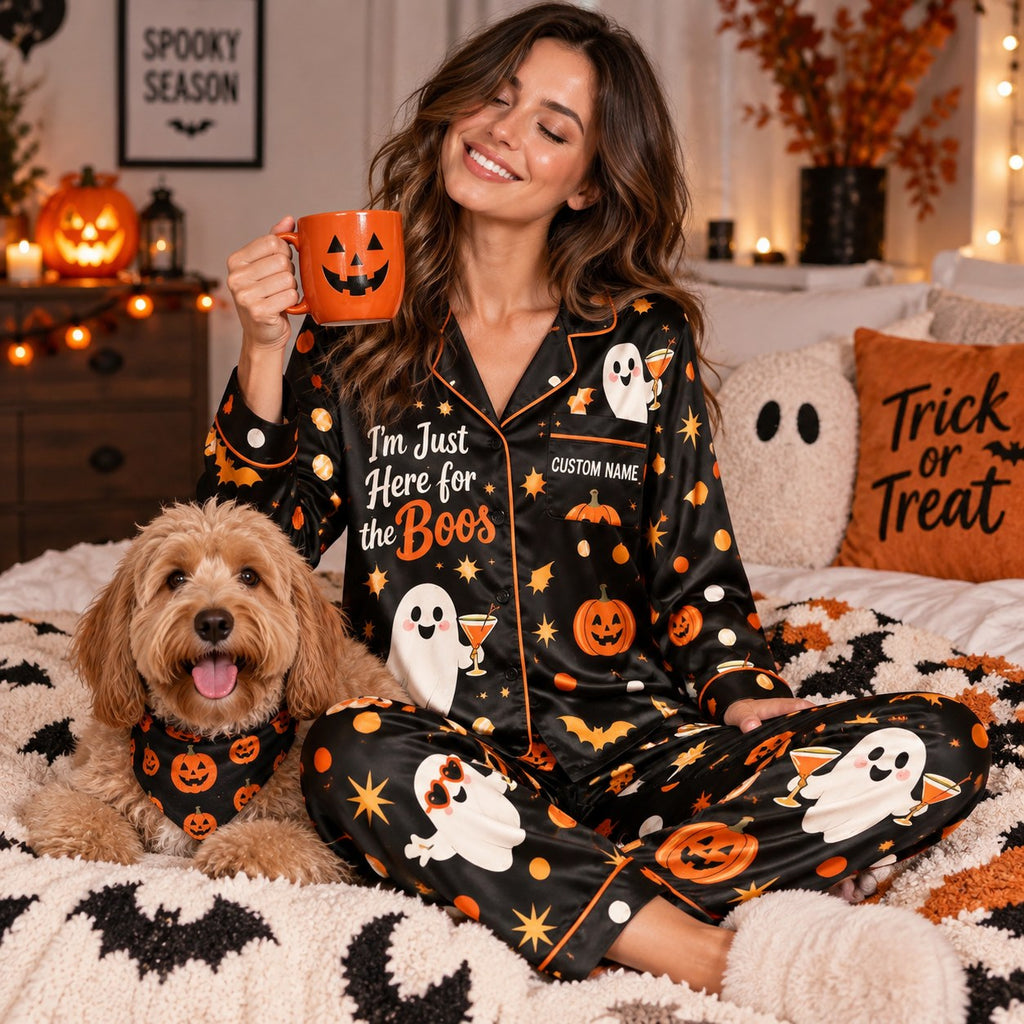 woman in a halloween satin pajama set on a bed next