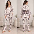 woman modeling a witchy halloween satin pajama set with moon and cat