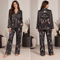 woman modeling a black satin pajama set with a meet me
