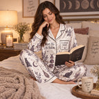 woman holding a mug in a halloween coven print satin pajama set