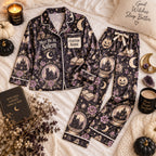black castle print satin pajamas flat lay with a custom name on the chest