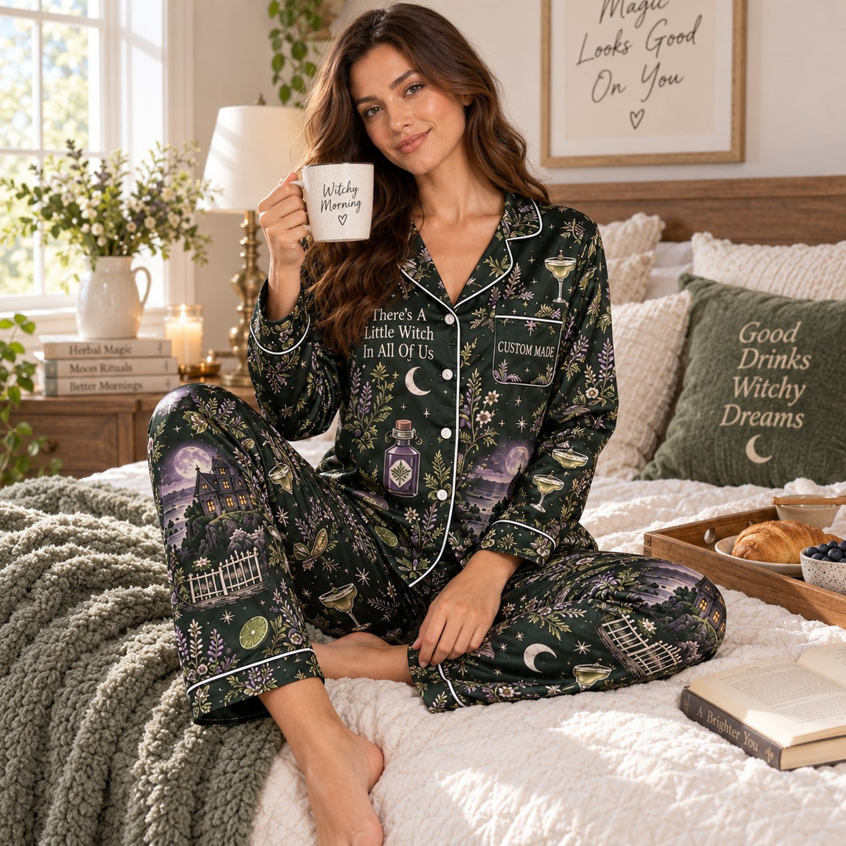 woman holding a margarita while wearing a witchy halloween satin pajama set