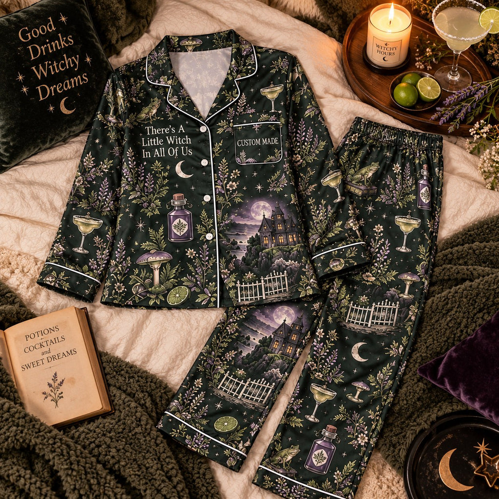 flat lay of dark green witchy botanical satin pajama set with haunted house print