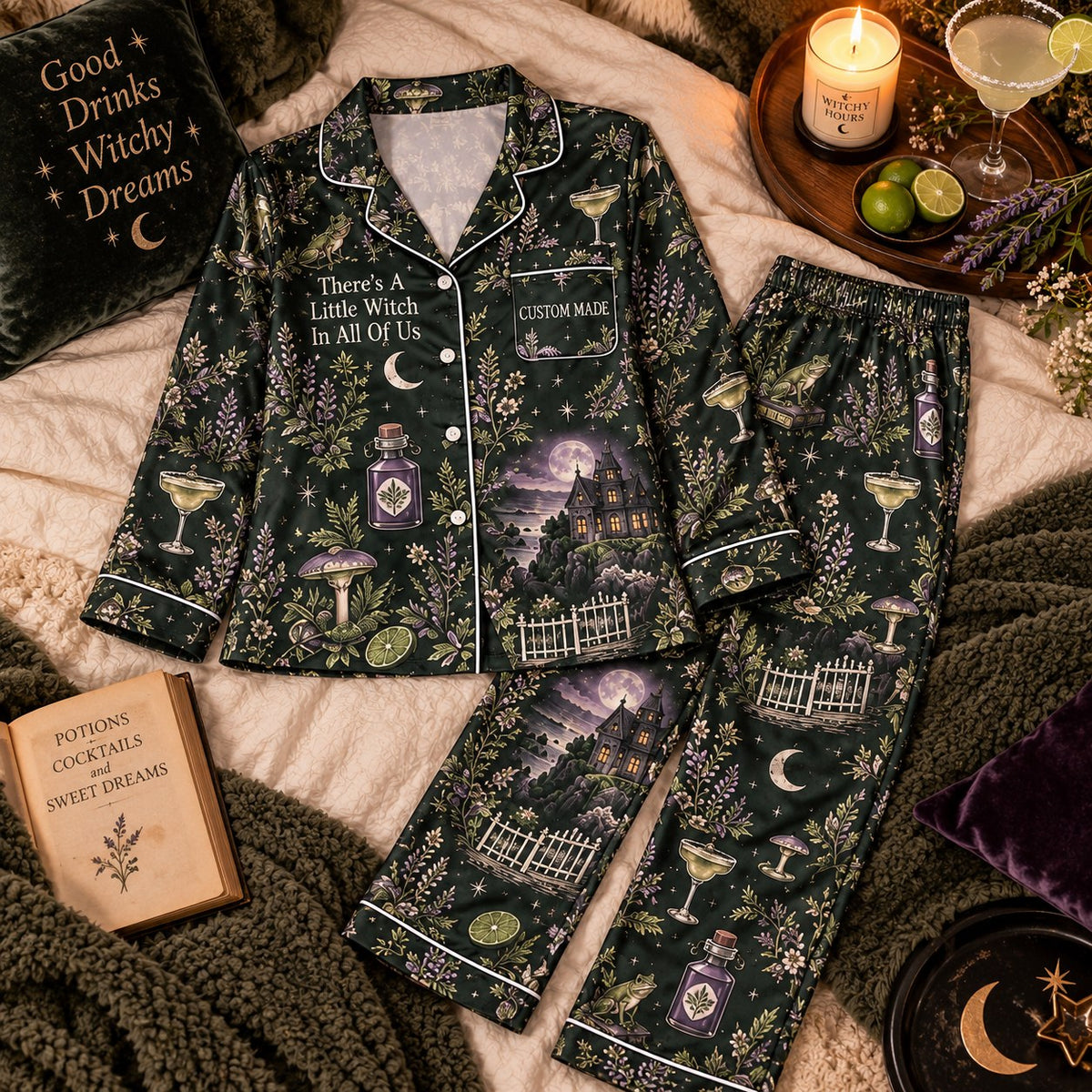 flat lay of dark green witchy botanical satin pajama set with haunted house print
