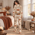 woman drinking coffee in autumn-hued halloween satin pajamas with piping
