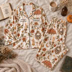 flat lay of cream skull satin pajamas with a custom name on the chest