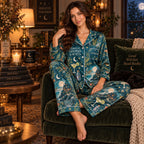 seated woman in teal moon satin pajamas with a custom name on the chest