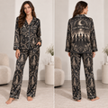 woman modeling black satin pajama set with witch coven and moon print