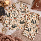 cream witch print satin pajamas flat lay with a custom name on the chest